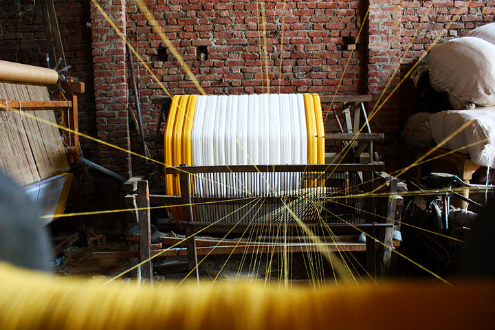 Artisan weaving fabric by hand — heritage craftsmanship behind Paul Ropp clothing