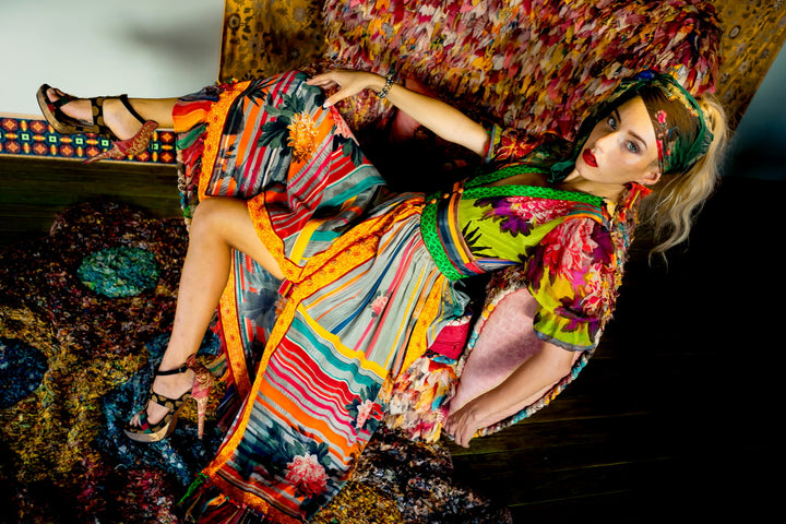 Model draped in flowing bold bohemian dress — expressive handcrafted resort wear from Bali by Paul Ropp
